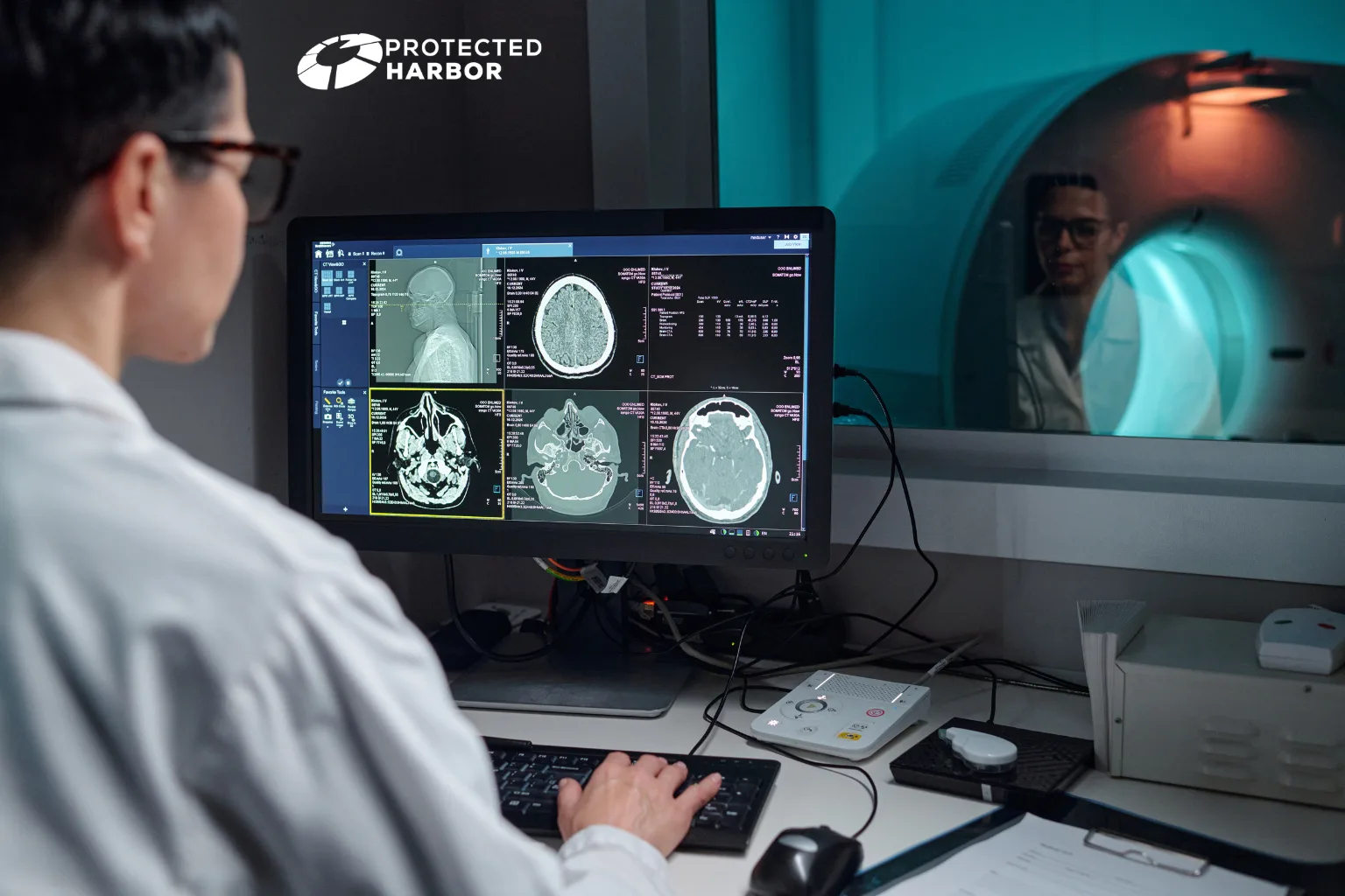 Securing PACS & Imaging Infrastructure: The image shows a radiology looking at a computer displaying brain scans with an MRI room in the background